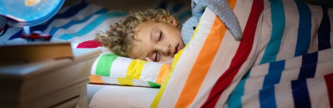 A child sleeping in bed.