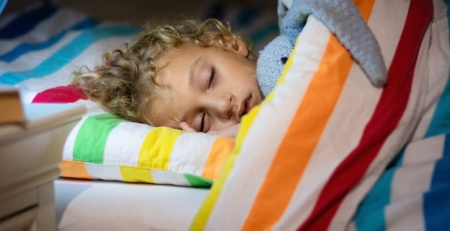 A child sleeping in bed.