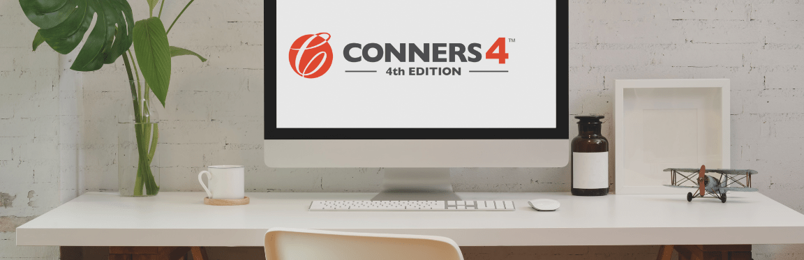 A computer on a desk with the Conners 4 logo displayed on the computer screen.